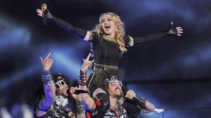 Singer Madonna (top) performs with Redfoo and Sky Blu (L) of LMFAO during the NFL Super Bowl XLVI game halftime show on February 5, 2012 at Lucas Oil Stadium in Indianapolis, Indiana.    AFP PHOTO / TIMOTHY A. CLARY (Photo credit should read TIMOTHY A. CLARY/AFP/Getty Images)