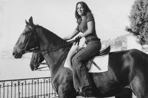 Joan Baez riding a horse in Switzerland circa 1973.