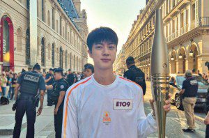 Jin of BTS participates in the Paris 2024 Olympic Torch Relay on July 14, 2024.