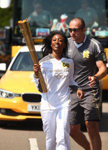 Beverley Knight carries the Olympic Flame on the Torch Relay leg through Brent (London Borough) during Day 68 of the London 2012 Olympic Torch Relay on July 25, 2012 in London, England.