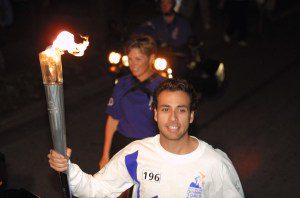 Howie Dorough carries the Olympic Flame during the 2002 Salt Lake Olympic Torch Relay on Dec. 7, 2001 in Winter Park, Florida.