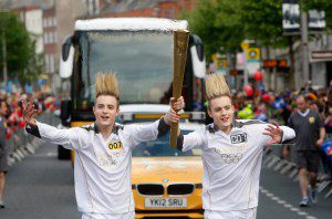 John (L) and Edward Grimes, aka Jedward, carry the Olympic Flame on day 19 of the London 2012 Olympic Torch Relay on June 6, 2012 in Dublin, Ireland.