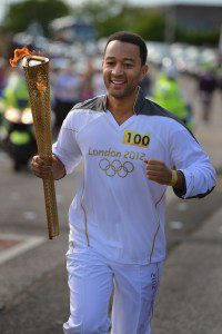 John Legend carries the Olympic Torch during the London 2012 Olympic Torch Relay on June, 13, 2012 in Edinburgh, Scotland.