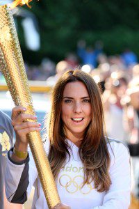 Melanie Chisholm carries the Olympic Flame on the Torch Relay leg between Birkenhead and Liverpool on day 14 of the London 2012 Olympic Torch Relay on June 1, 2012 in Birkenhead, England.