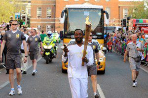 Will.i.am carries the Olympic flame on May 21, 2012 in Taunton, England.