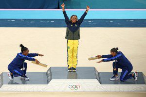 PARIS, FRANCE - AUGUST 05: Gold medalist Rebeca Andrade (C) of Team Brazil, silver medalist Simone Biles (L) of Team United States and bronze medalist Jordan Chiles (R) of Team United States celebrate on the podium at the Artistic Gymnastics Women's Floor Exercise Medal Ceremony on day ten of the Olympic Games Paris 2024 at Bercy Arena on August 05, 2024 in Paris, France. (Photo by Elsa/Getty Images)